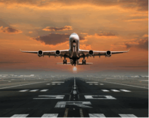 Commercial airplane taking off at sunrise, symbolizing the strength, precision, and reliability of aerospace forgings.